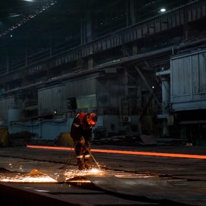 Worker doing a industrial welding at a steel mill
